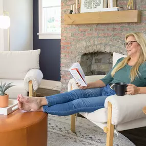 woman sitting on a chair reading