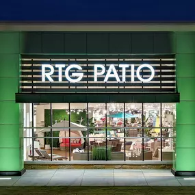 Close-up of RTG Patio signage and showroom interior at night.