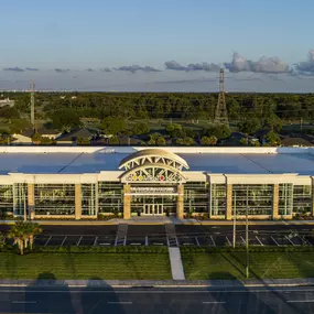 Aerial view of Rooms To Go showroom surrounded by greenery and open parking.