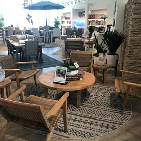 Cozy woven teak patio set with a round wooden coffee table and a natural aesthetic.