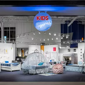 RTG Kids & Teens furniture showroom showing a carriage bed and other kids beds in white and blue.