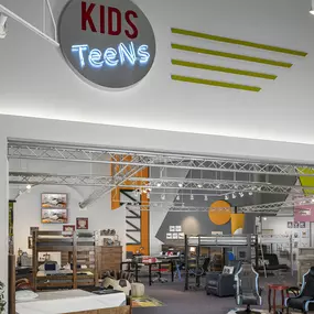 Kids and Teens furniture section in a vibrant showroom.