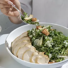 High-protein Kale Caesar Salad with chicken, nutrient-rich
greens, and wholesome ingredients.