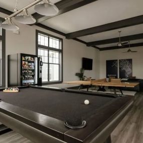 Community game room with vending machine and multiple game options including a pool table and ping pong table.
