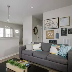 Furnished living room with mounted Tvs.