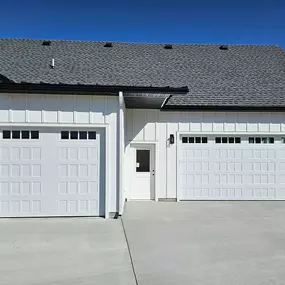 Modern white garage doors installed by Beacon Garage Doors, showcasing our expertise in residential garage door installations in Weber and Davis Counties.