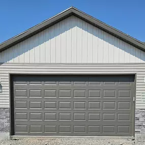 Example of a gray garage door installed by Beacon Garage Doors. We proudly provide garage door installation, repair, and maintenance services to customers in Roy, Clinton, Sunset, West Point, and Syracuse, UT.