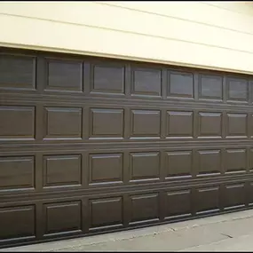 Elegant brown garage door installation in Syracuse, Utah. Installed by Beacon Garage Doors, featuring a durable paneled design for enhanced curb appeal, security, and smooth operation.