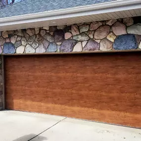 Beautiful wood-finish garage door installation in Clinton, Utah. Installed by Beacon Garage Doors, this modern door enhances curb appeal while providing durability and smooth operation.