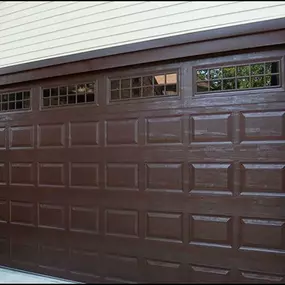 Elegant brown garage door installation in Syracuse, Utah. Professionally installed by Beacon Garage Doors, featuring decorative windows for enhanced curb appeal and durability.