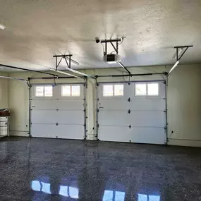 Spacious residential garage with modern garage door installation in Ogden, Utah, by Beacon Garage Doors.