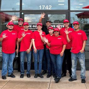 Employees pose for a photograph ahead of the grand opening of the Five Guys restaurant at 1742 North Main Street in Salinas, California.