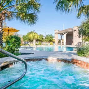 Resort style pool with spacious sundeck and a hot tub with cabanas.