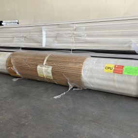 A picture of a roll up garage door still in the packaging on the floor