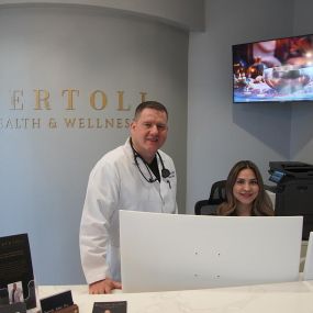 Dr. Troy Bertoli and Vanessa behind the front counter