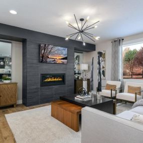 Cozy linear fireplace with tile surround in spacious great room