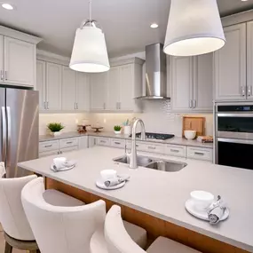 Beautiful kitchen with contrasting warm island cabinets and cream perimeter cabinets