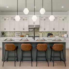 Chef inspired kitchen with gas range, large center island, and abundant cabinet space