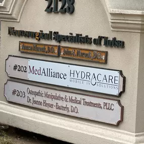 Sign out front of HydraCare's location in Tulsa showing you the Suite number of 202