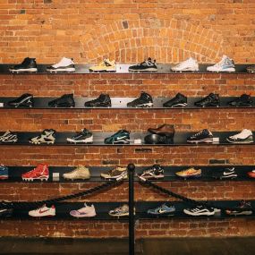 Display of exclusive sneakers at HOMETEAM SEATTLE, secured behind a museum-style barrier.