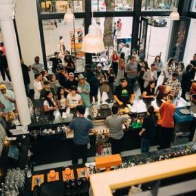 Crowd seen from above ordering at the bar inside HOMETEAM SEATTLE.