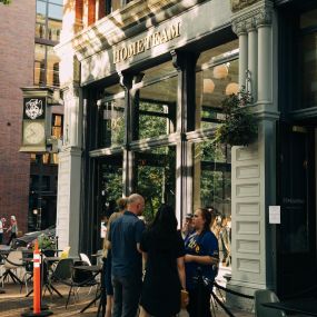 The inviting storefront of HOMETEAM SEATTLE, a premier sneaker store with limited edition sneakers and an indoor restaurant.