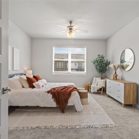 a bedroom with a bed and a ceiling fan