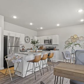 a kitchen and dining room with a table and chairs