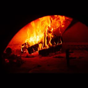 The wood fire oven burns daily at Caffé at Luminosa