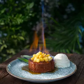 NEW! FLAMING PINEAPPLE BUTTER CAKE: Our warm housemade butter cake topped with fresh pineapple, salted rum caramel, vanilla ice cream, tableside Goslings Rum flambé