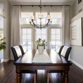 Motorized window shadings & drapery in dining room.