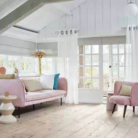 A minimalistic drape and Roman shade combo was the perfect touch to maintain this room's chic vibe. Our design consultants can help you choose the right look for your room. Contact us to schedule your free consultation!