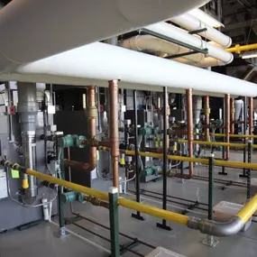 High-efficiency boiler system installed by BC TenAir, featuring insulated piping, advanced control valves, and energy-efficient components for optimal heating performance in an industrial setting