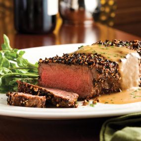 14 oz Dry Aged NY Strip au Poivre finished with our housemade Courvoisier Cream for a decadent finish.