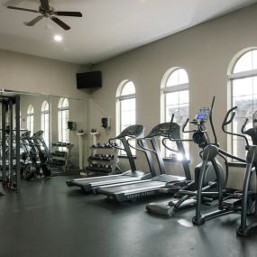 24-Hour Fitness Center with cardio machines and free weights.