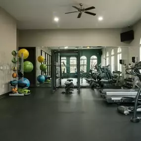 24-Hour Fitness Center with cardio machines and free weights.