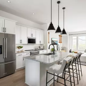 Gourmet kitchen boasts a large center island and stainless steel appliances