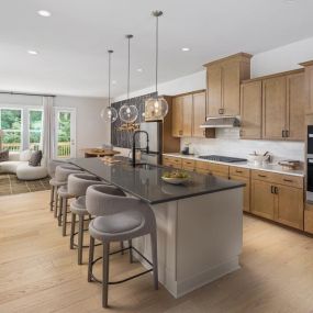 Generously sized kitchens featuring large islands with abundant cabinet and countertop space