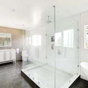 Luxurious rehab bathroom featuring a glass-enclosed shower, elegant freestanding tub, and modern vanity. Clients can enjoy a spa-like experience in this beautifully designed bathroom.