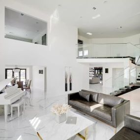 Stunning los angeles addiction treatment center with an open floor plan, featuring glass railing and luxury furnishings. This bright and airy space is designed to provide comfort and tranquility for clients during their recovery.
