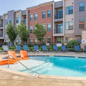 A resort style pool with chairs