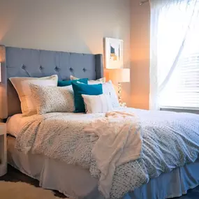 A bedroom with a bed and a window