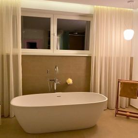 In diesem zeitlos eleganten Badezimmer dominieren neutrale Farben und eine einladende Atmosphäre. Die großen Natursteinfliesen in einem schönen Beige-Grau Ton verleihen dem Raum eine edle Note.
