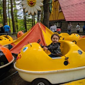 little boy on theme park ride