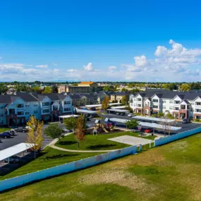 Aerial view of the Eagles Landing neighborhood with apartment buildings and a green area with a playground