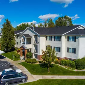 Eagles Landing apartment building with cars parked in reserved resident parking