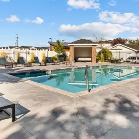 Swimming Pool with lounge seating surrounding perimeter