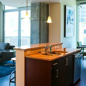 Open concept living room with 9ft ceilings and floor to ceiling windows.