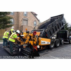 Dominion Paving workers standing behind work truck