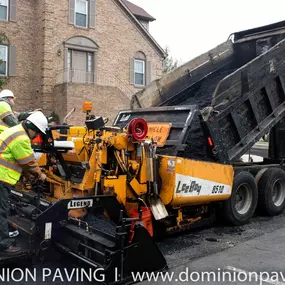 Dominion Paving workers standing behind work truck